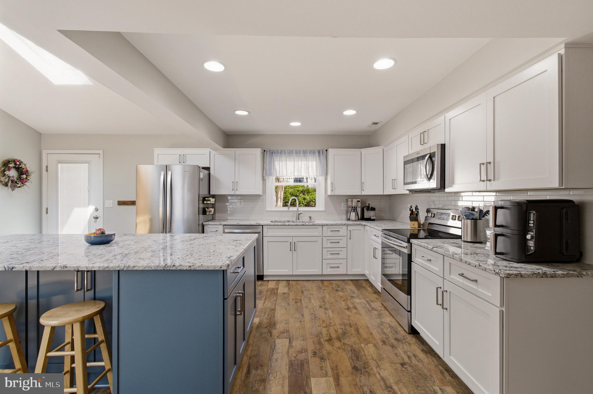 1410 Knights Bridge Turn Crofton, MD 21114 - Photo 7 of 75 a kitchen with granite countertop cabinets stainless steel appliances a sink and counter space