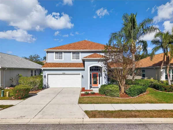 a front view of a house with a yard and garage