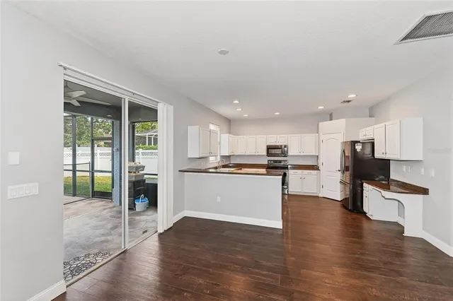 a view of kitchen with stove and wooden floor