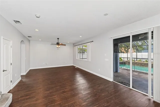 wooden floor in an empty room with a window
