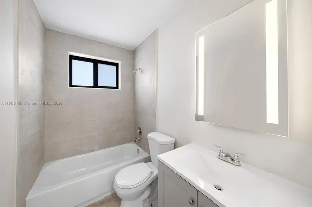 a bathroom with a toilet a sink and bathtub