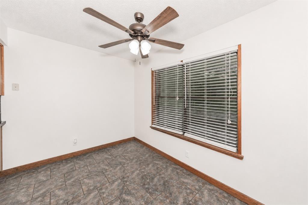 1001 Rosebud Drive Azle, TX 76020 - Photo 13 of 36 Room featuring tile flooring, white walls, and a ceiling fan with integrated lighting