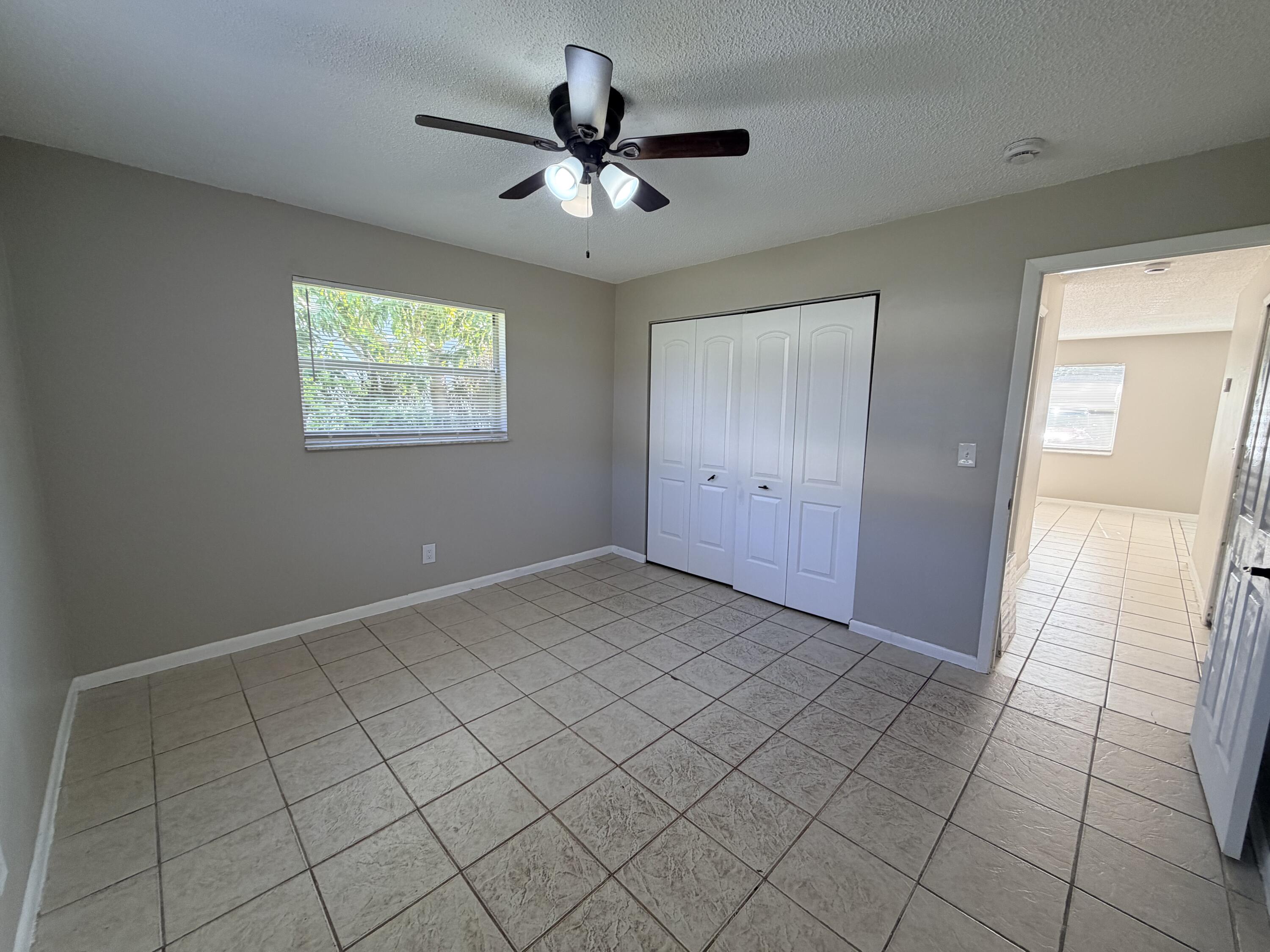 3594 Almar Road, Unit 3 Lake Worth, FL 33461 - Photo 6 of 15 an empty room with fan and windows
