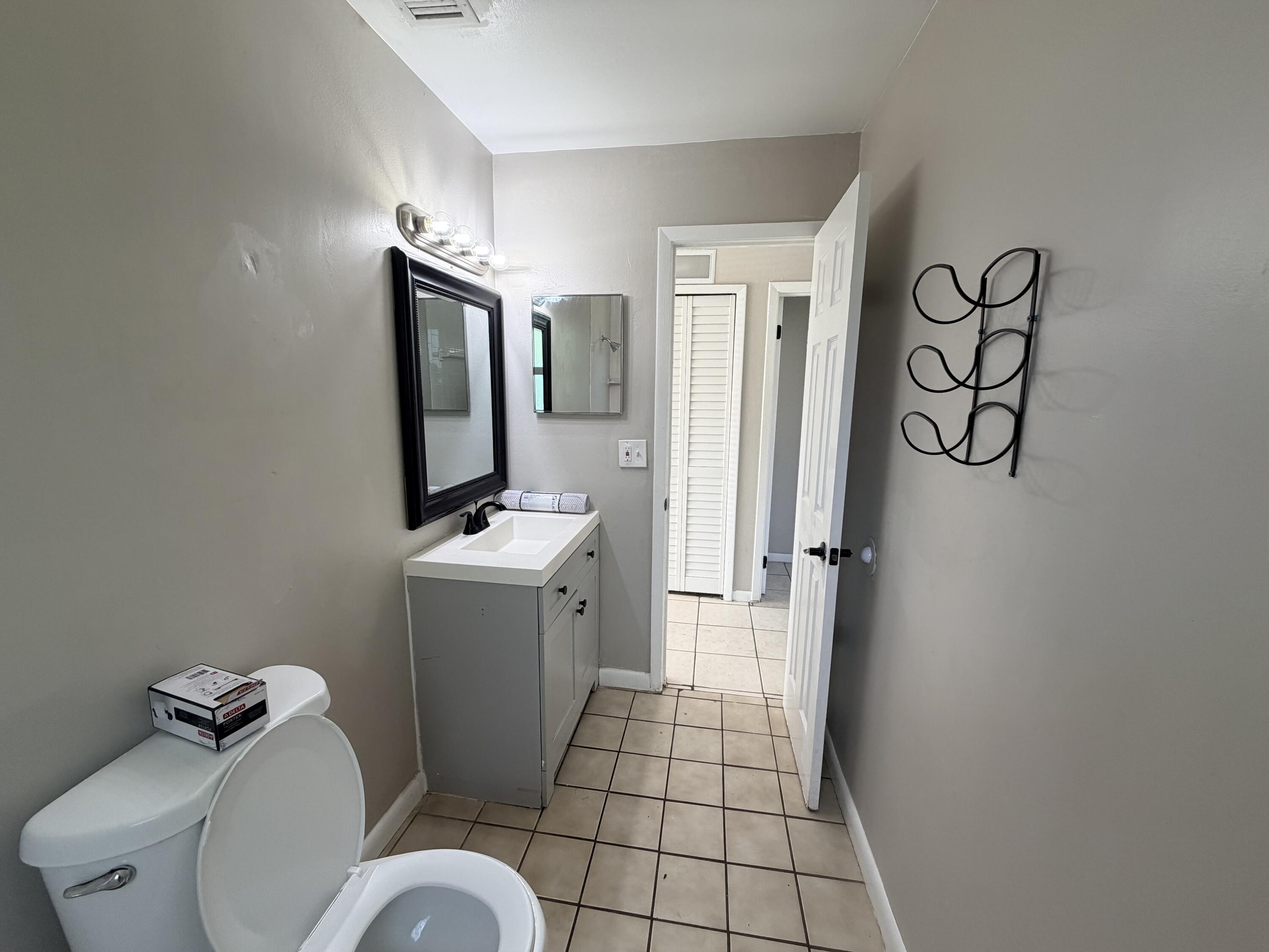 3594 Almar Road, Unit 3 Lake Worth, FL 33461 - Photo 8 of 15 a bathroom with a sink toilet and shower