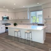 a kitchen with a sink a window and stainless steel appliances
