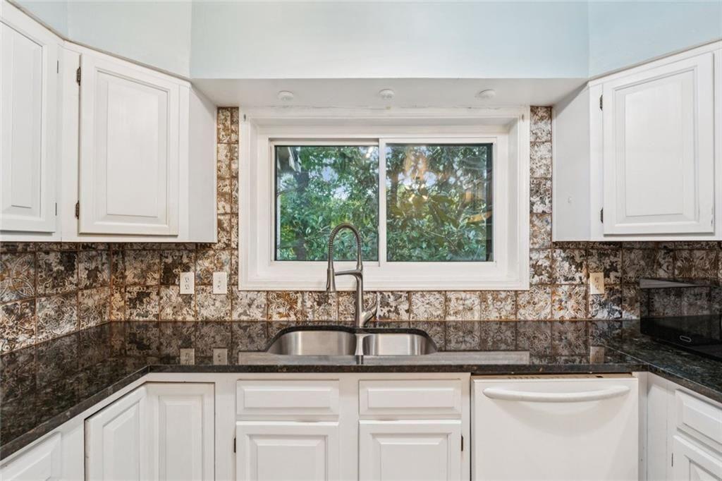 1205 Killarney Southeast Smyrna, GA 30080 - Photo 18 of 58 a kitchen with stainless steel appliances white cabinets and a sink