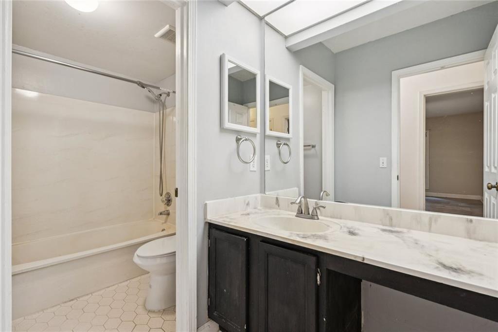 1205 Killarney Southeast Smyrna, GA 30080 - Photo 27 of 58 a bathroom with a granite countertop sink toilet and shower
