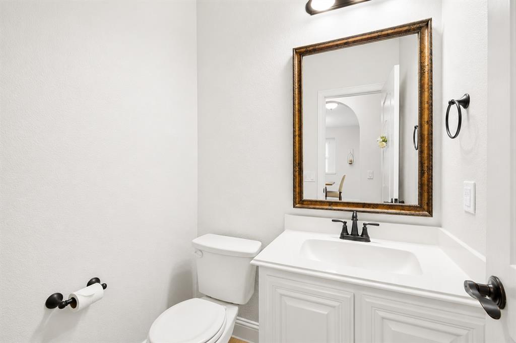 924 Timber Ridge Drive Justin, TX 76247 - Photo 5 of 32 White vanity with paneled cabinetry, integrated sink, and white countertop