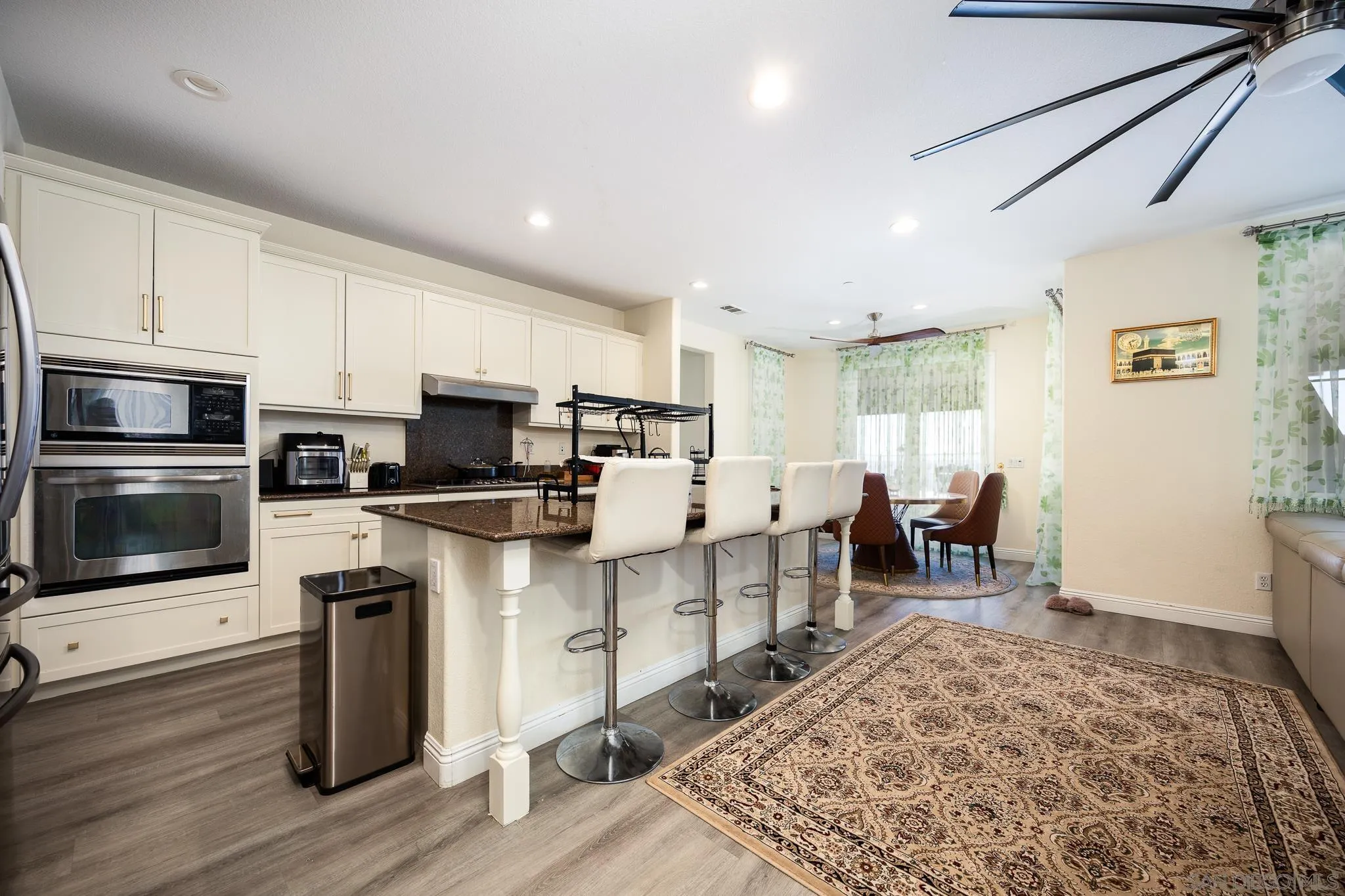 5120 Sevilla Street Santee, CA 92071 - Photo 11 of 44 a living room with stainless steel appliances kitchen island granite countertop furniture wooden floor and a window