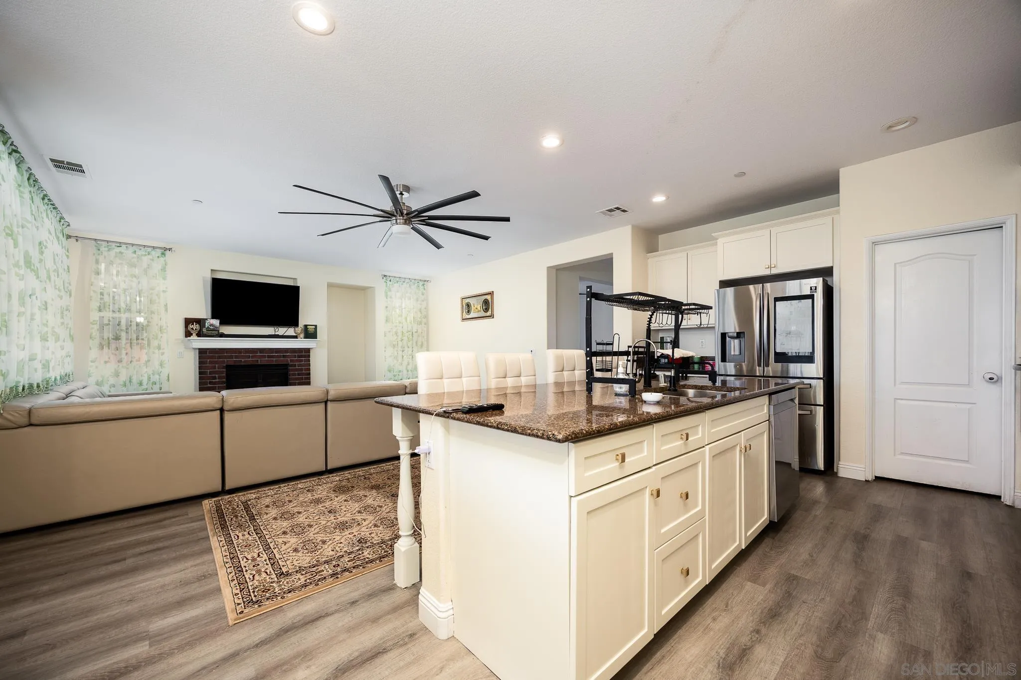 5120 Sevilla Street Santee, CA 92071 - Photo 13 of 44 a kitchen with stainless steel appliances granite countertop a sink stove and refrigerator