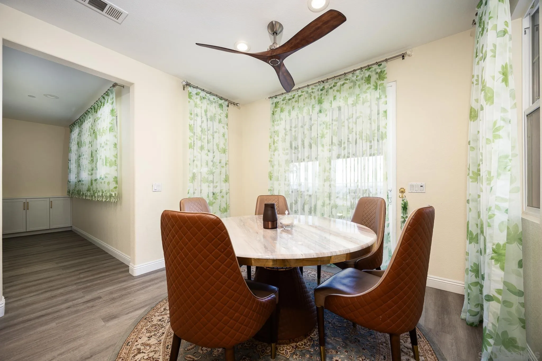 5120 Sevilla Street Santee, CA 92071 - Photo 17 of 44 a dining room with furniture a chandelier and wooden floor