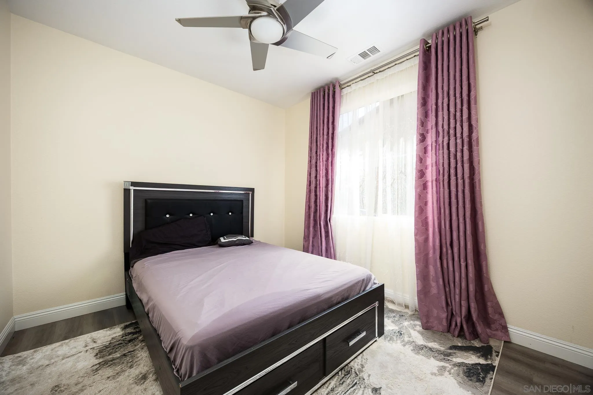 5120 Sevilla Street Santee, CA 92071 - Photo 18 of 44 a bed sitting in a bedroom next to a window