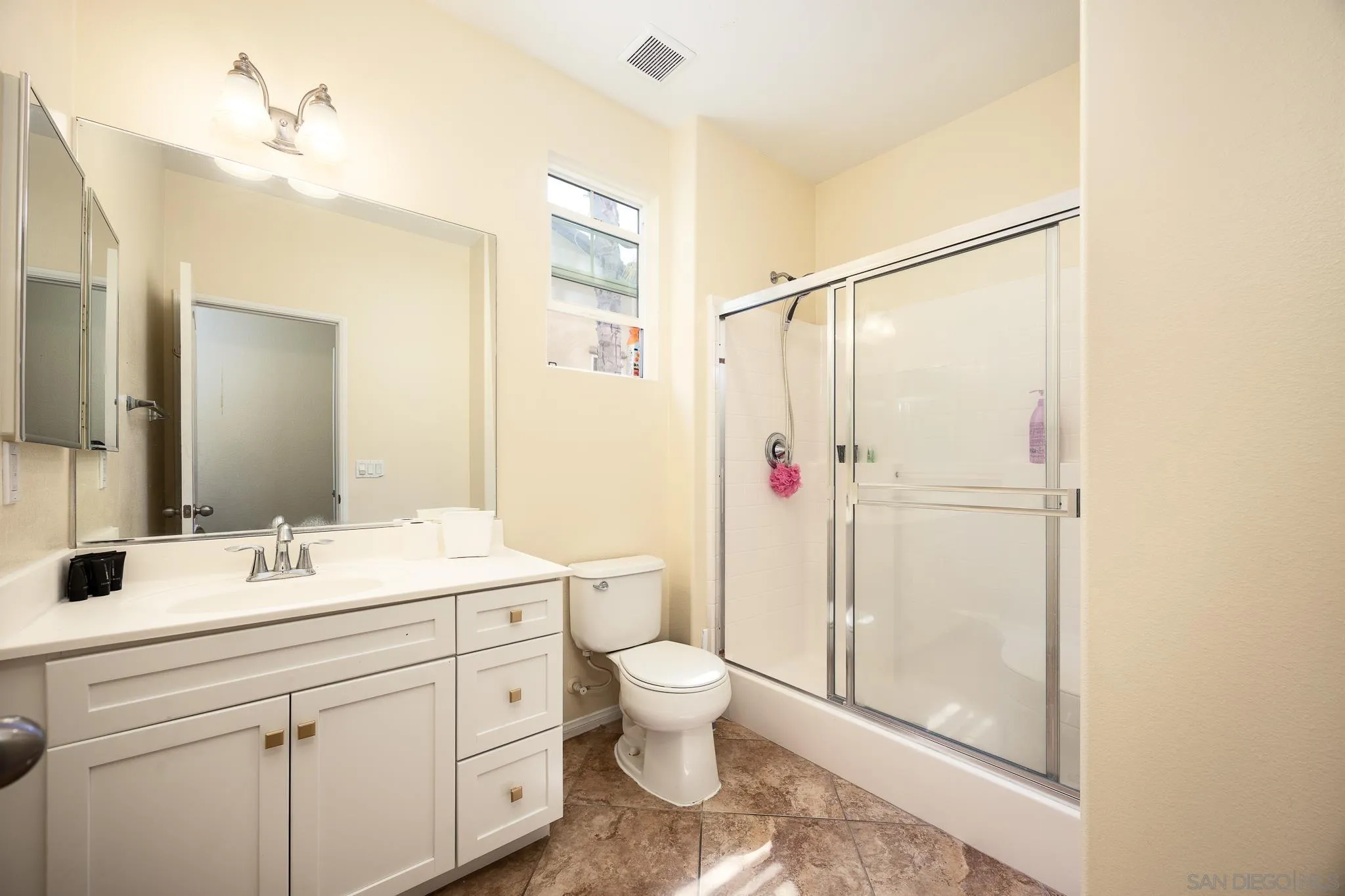 5120 Sevilla Street Santee, CA 92071 - Photo 19 of 44 a bathroom with a double vanity sink toilet and shower
