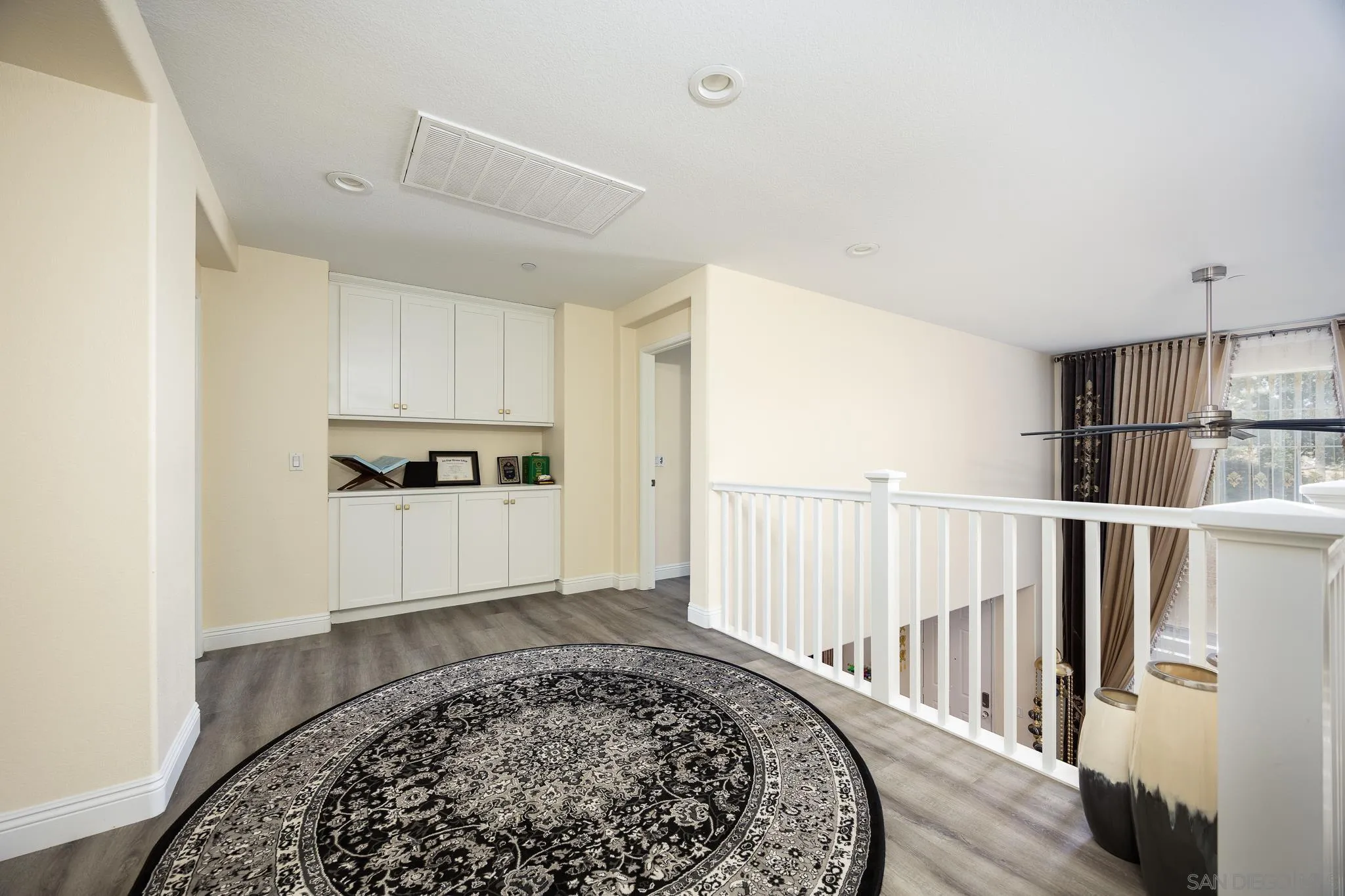 5120 Sevilla Street Santee, CA 92071 - Photo 20 of 44 a view of a hallway with wooden floor and staircase