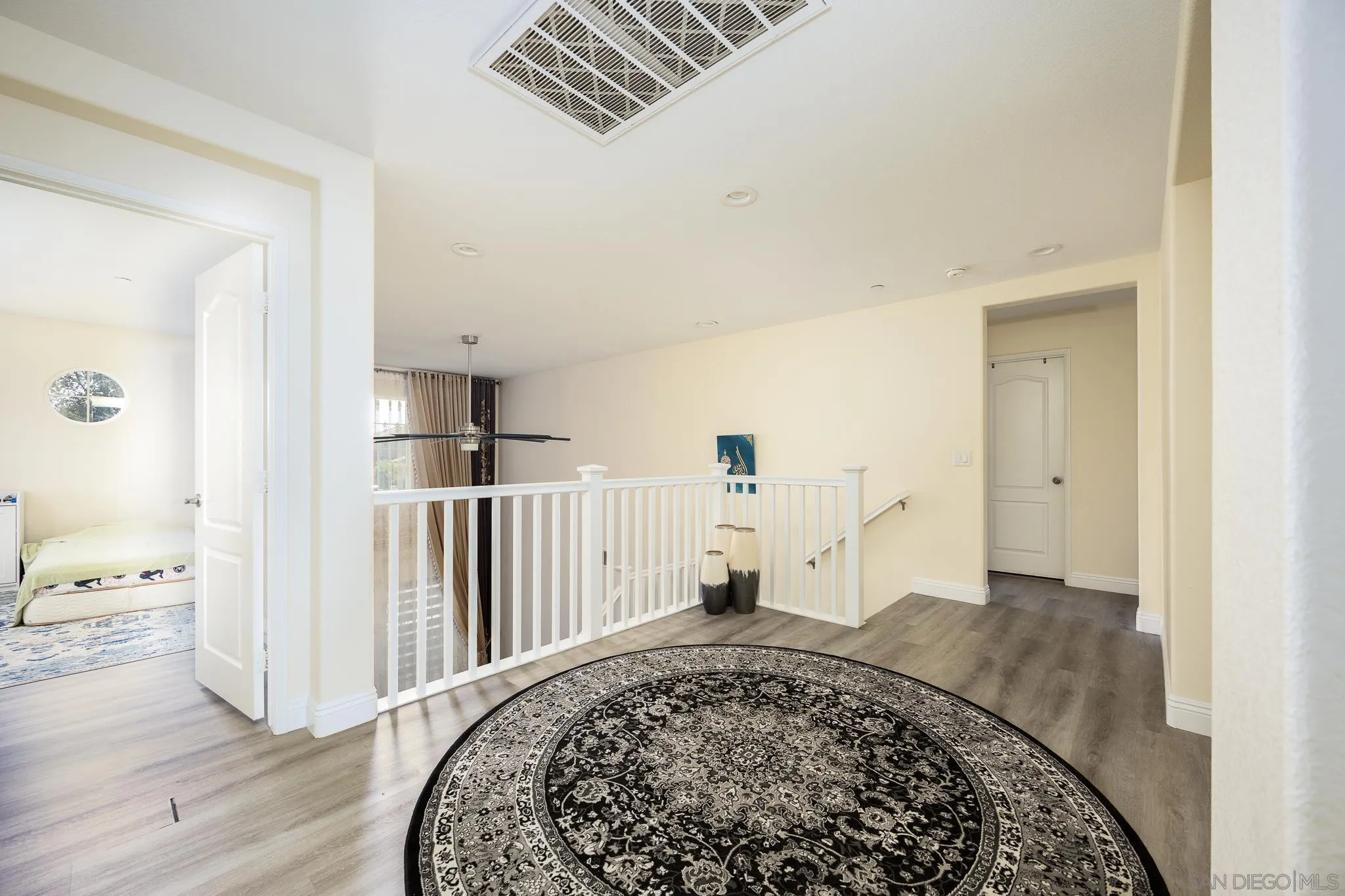 5120 Sevilla Street Santee, CA 92071 - Photo 21 of 44 a view of a livingroom with wooden floor and a rug
