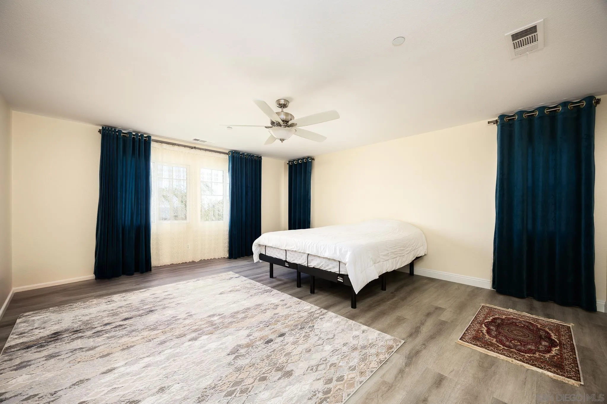 5120 Sevilla Street Santee, CA 92071 - Photo 22 of 44 a spacious bedroom with a bed and a window