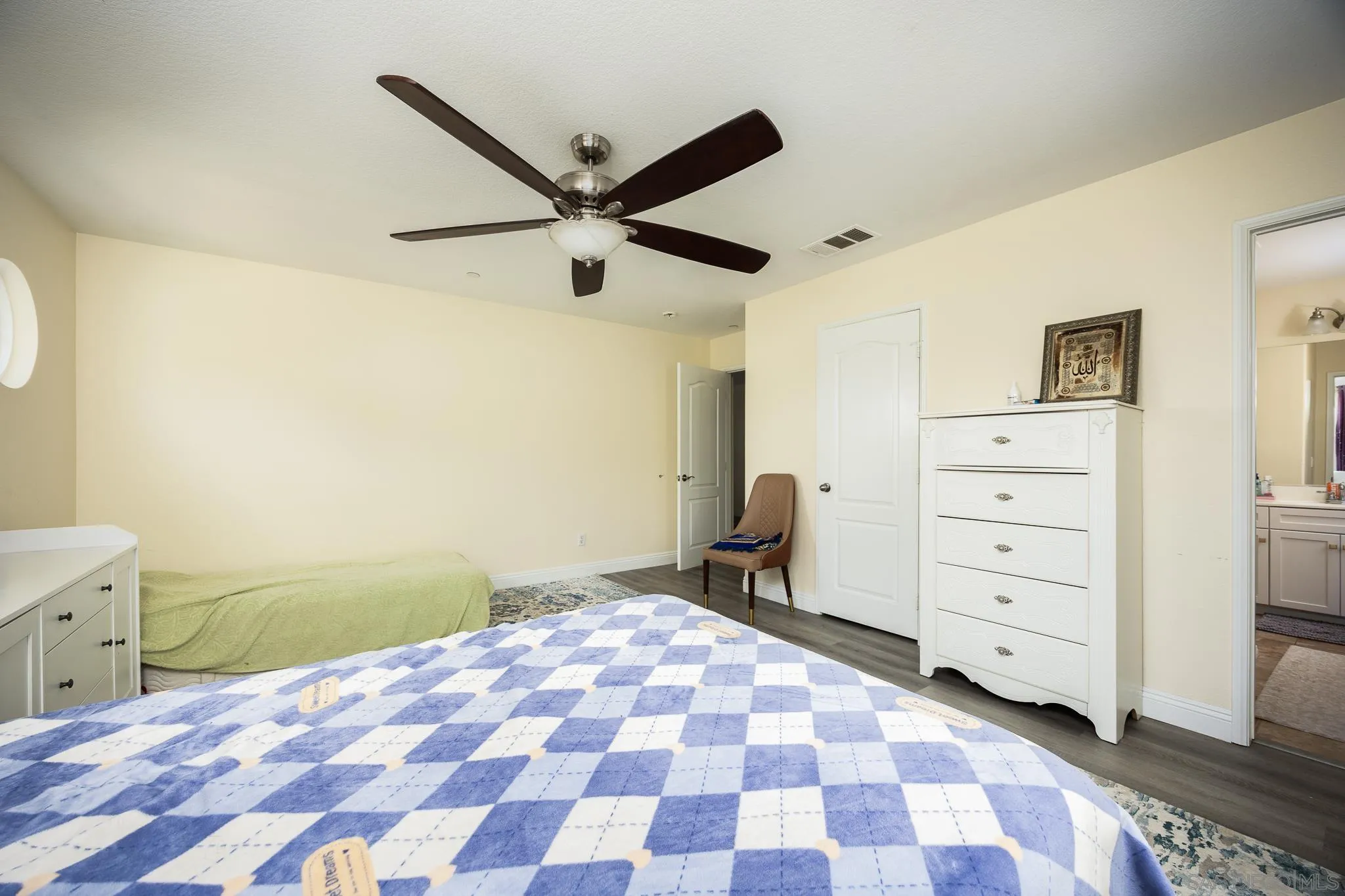 5120 Sevilla Street Santee, CA 92071 - Photo 27 of 44 a bedroom with a bed and a lamp on the dresser