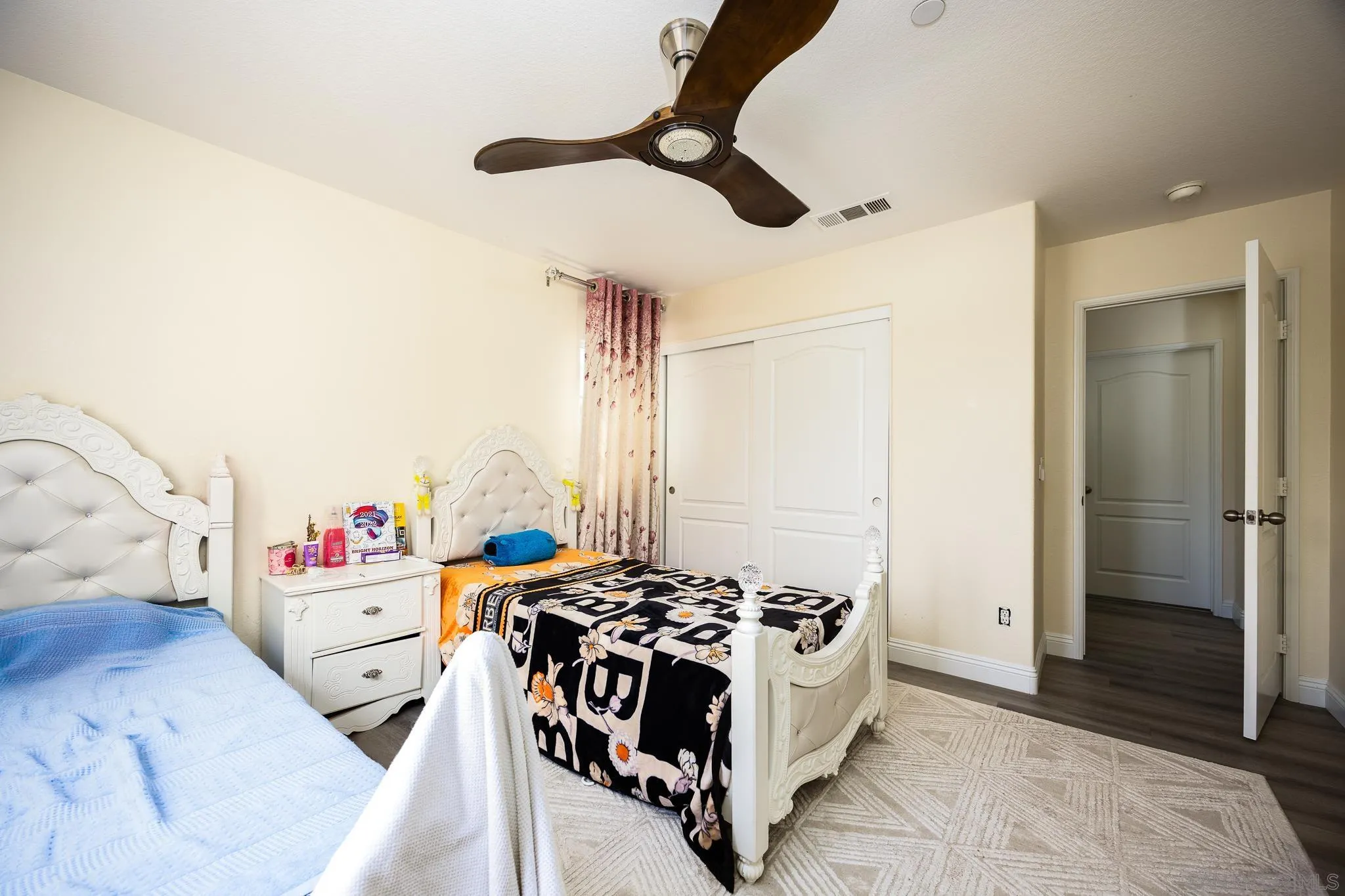 5120 Sevilla Street Santee, CA 92071 - Photo 29 of 44 a bedroom with a bed and a chandelier