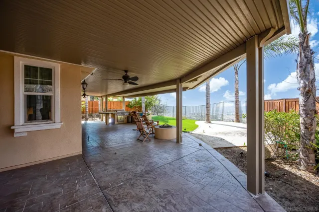 a front view of a house with sitting area and garden