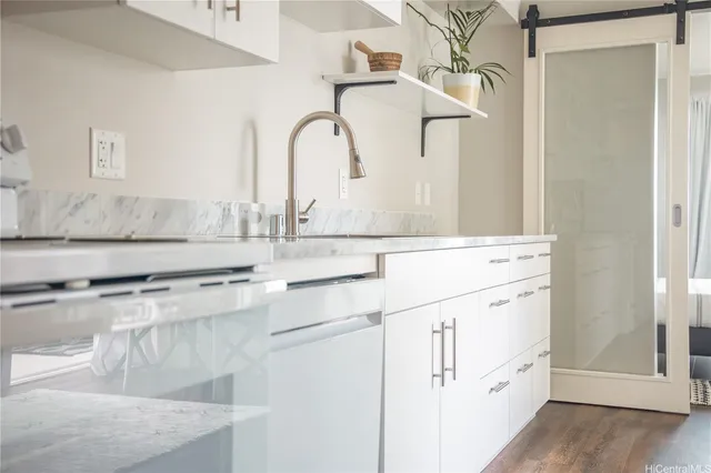 a bathroom with cabinets a sink and a window