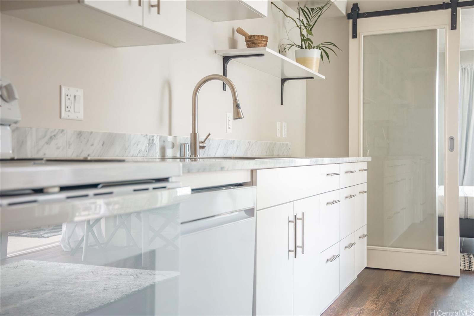 803 Waimanu Street, Unit 512 Honolulu, HI 96813 - Photo 13 of 18 a bathroom with cabinets a sink and a window