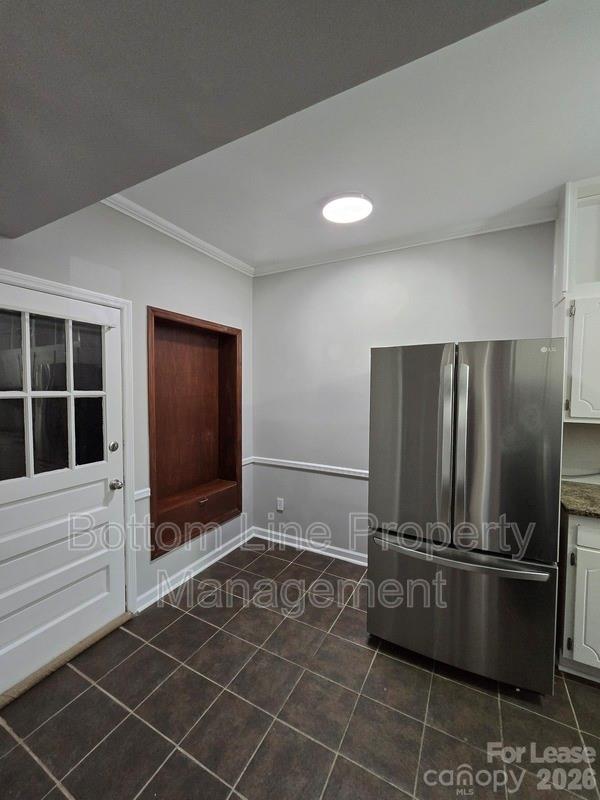 5949 Quail Hollow Road, Unit D Charlotte, NC 28210 - Photo 15 of 34 a view of a refrigerator in kitchen and wooden floor