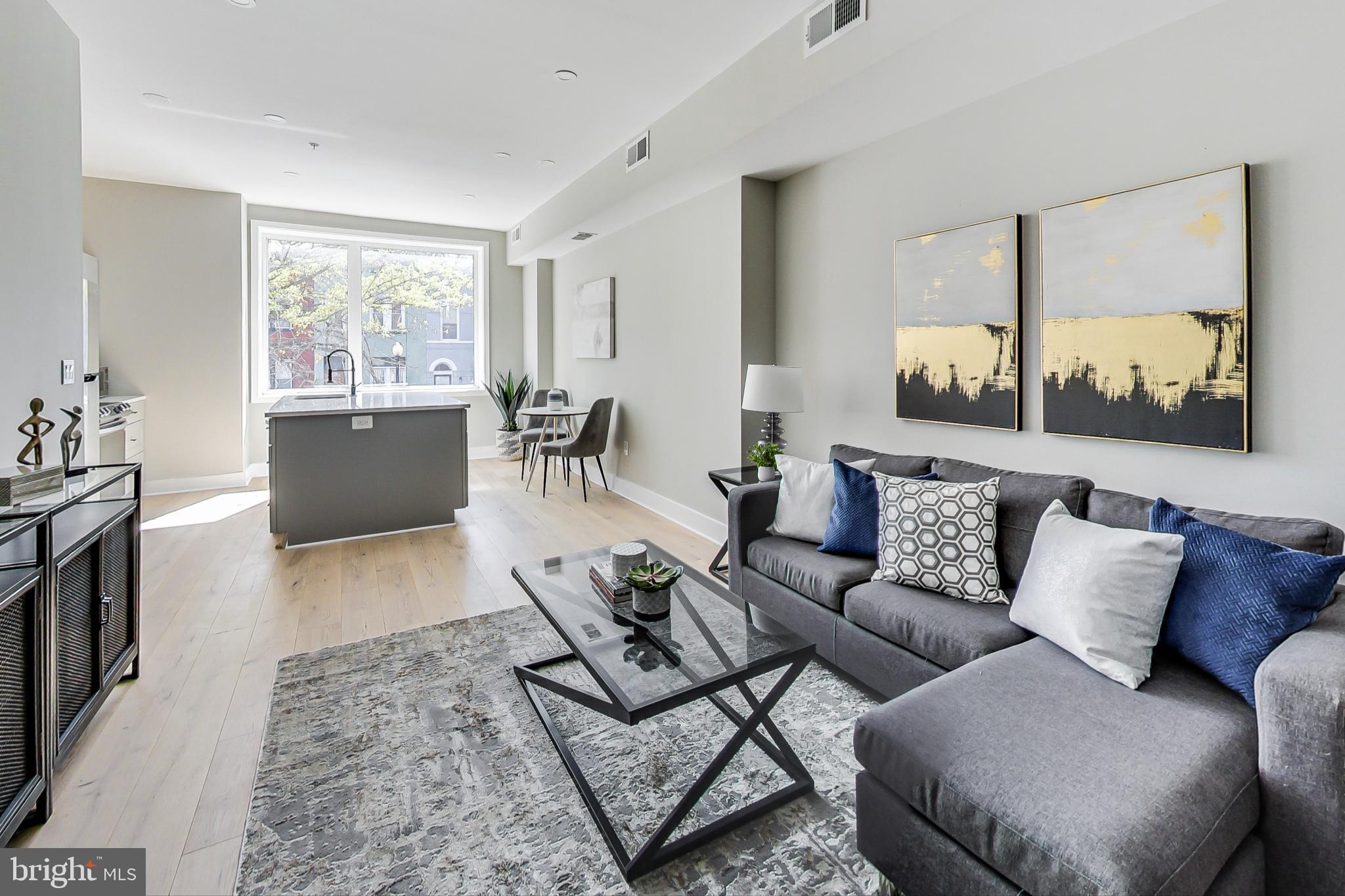 207 Florida Avenue Northwest, Unit 1 Washington, DC 20001 - Photo 1 of 26 a living room with furniture and a large window