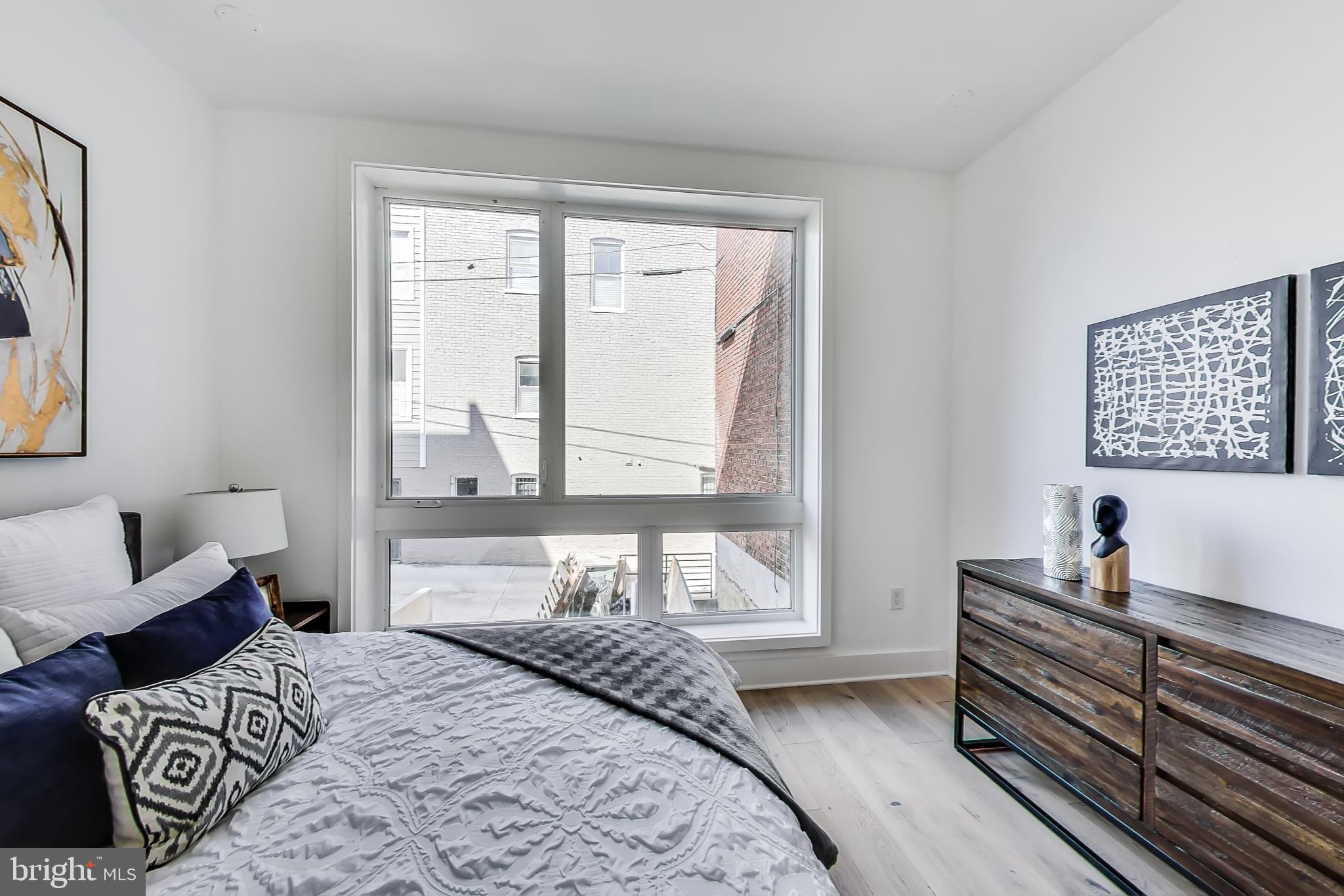 207 Florida Avenue Northwest, Unit 1 Washington, DC 20001 - Photo 11 of 26 a bedroom with a bed and wooden floor