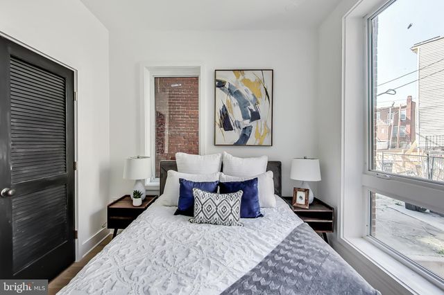 a bed room with a bed and a painting on the wall