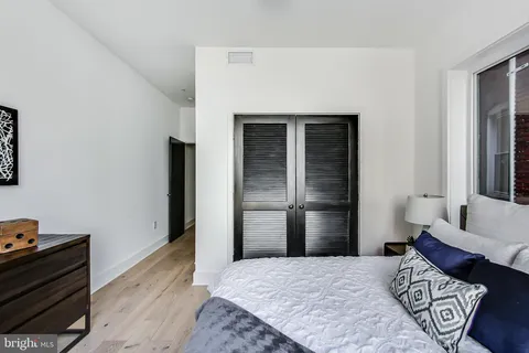 a bedroom with a bed and a couch