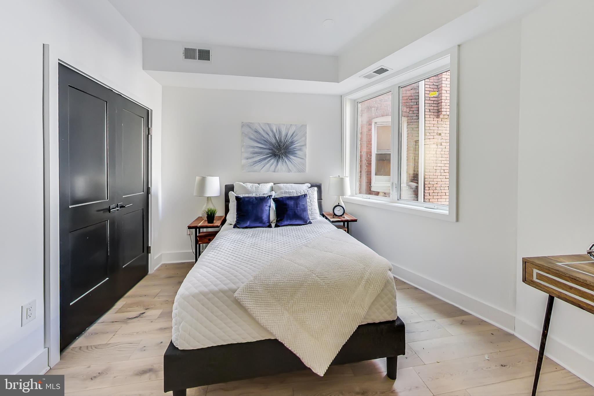 207 Florida Avenue Northwest, Unit 1 Washington, DC 20001 - Photo 17 of 26 a bedroom with a bed and wooden floor