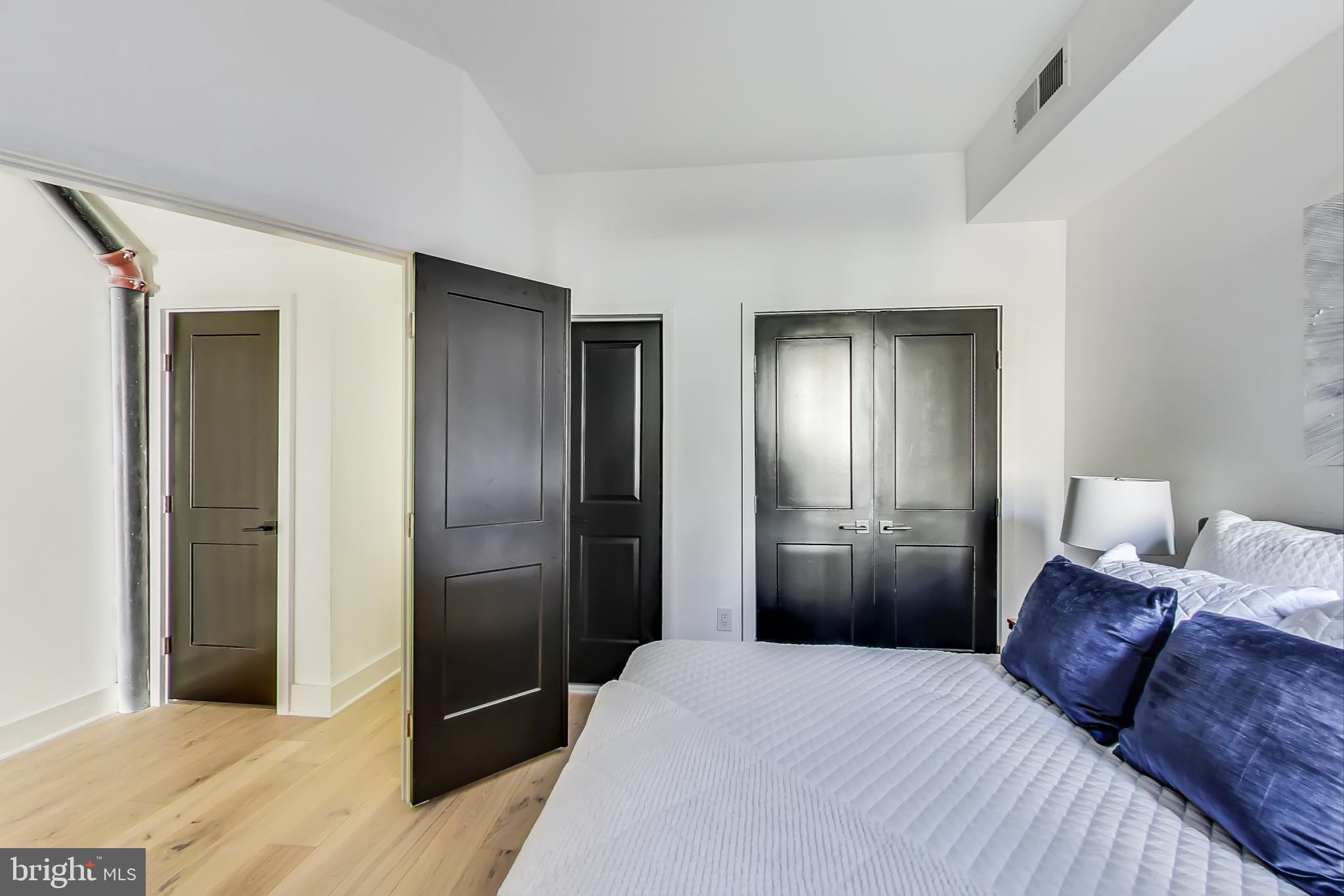207 Florida Avenue Northwest, Unit 1 Washington, DC 20001 - Photo 18 of 26 a bedroom with a bed and a refrigerator