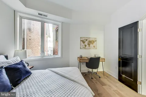 a bedroom with a bed and a couch