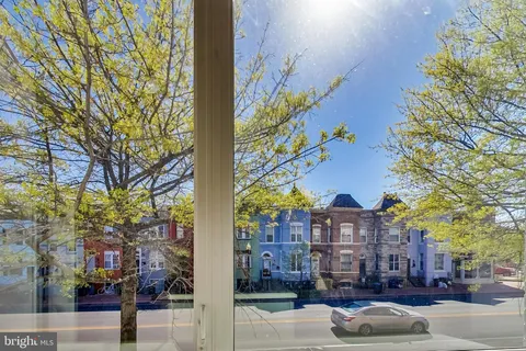 a city street lined with buildings and trees