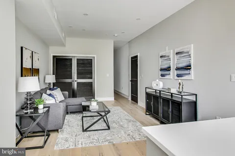 a living room with furniture a rug and a window