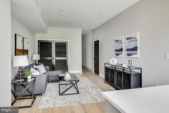 a living room with furniture a rug and a window
