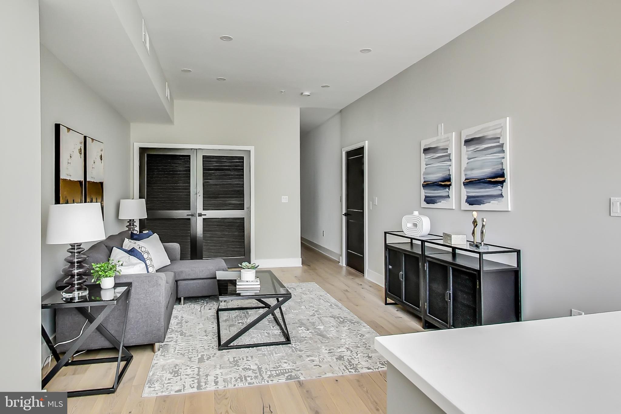 207 Florida Avenue Northwest, Unit 1 Washington, DC 20001 - Photo 3 of 26 a living room with furniture a rug and a window