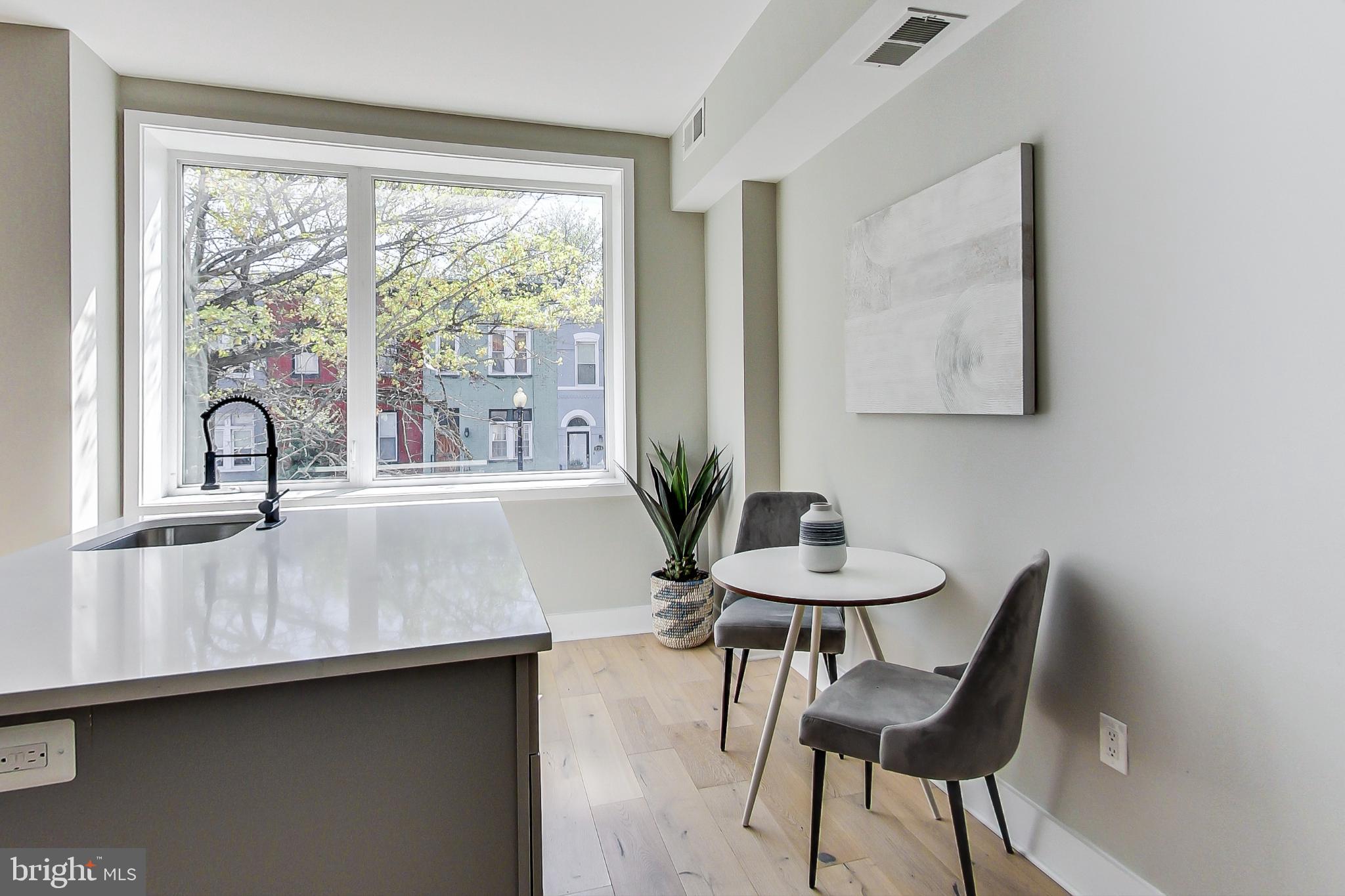207 Florida Avenue Northwest, Unit 1 Washington, DC 20001 - Photo 5 of 26 a kitchen with a table chairs and a sink