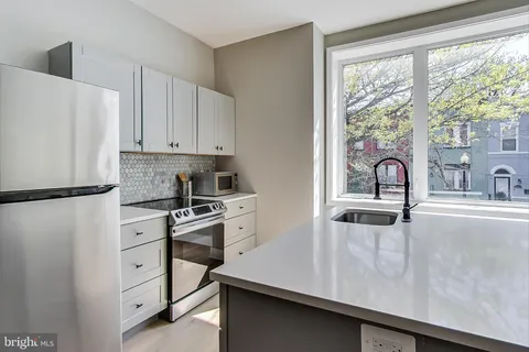 a kitchen with appliances cabinets and a sink