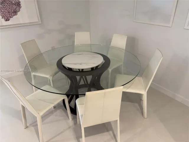 a dining room with a table and chairs