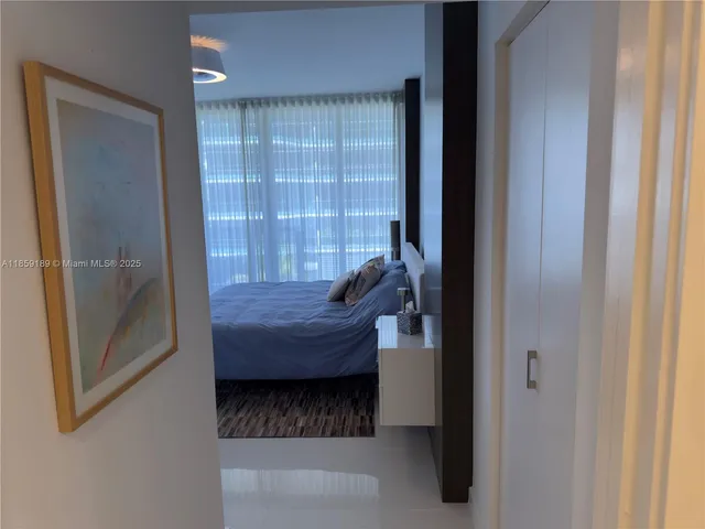 a bedroom with a bed and a flat tv screen