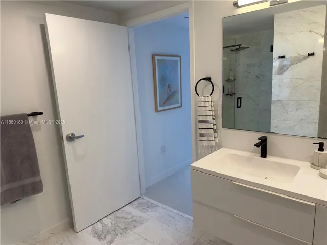 a white toilet sitting next to a bath tub