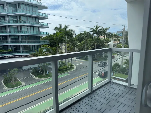 a view of a patio with a table and chairs potted plants