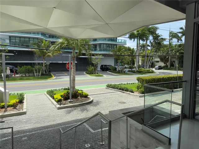 a front view of a building with a garden and plants