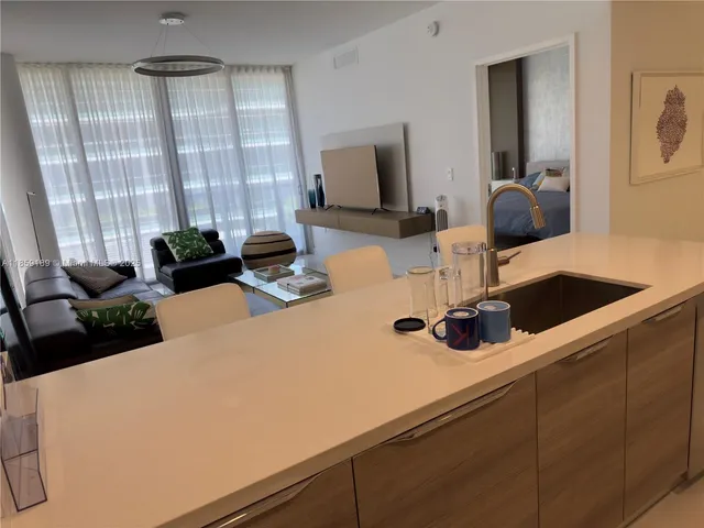 a kitchen with a refrigerator and a sink