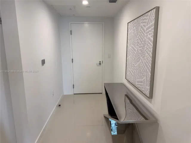 a bathroom with a toilet and a mirror