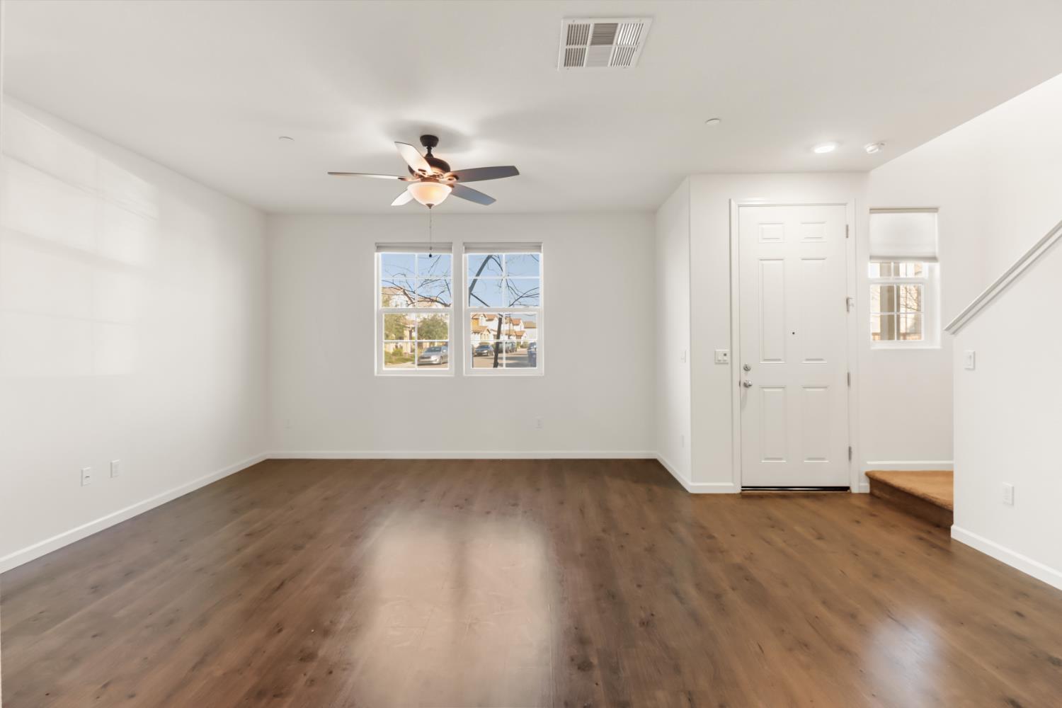 3230 Chelmer Way Rancho Cordova, CA 95670 - Photo 6 of 50 an empty room with wooden floor chandelier fan and windows