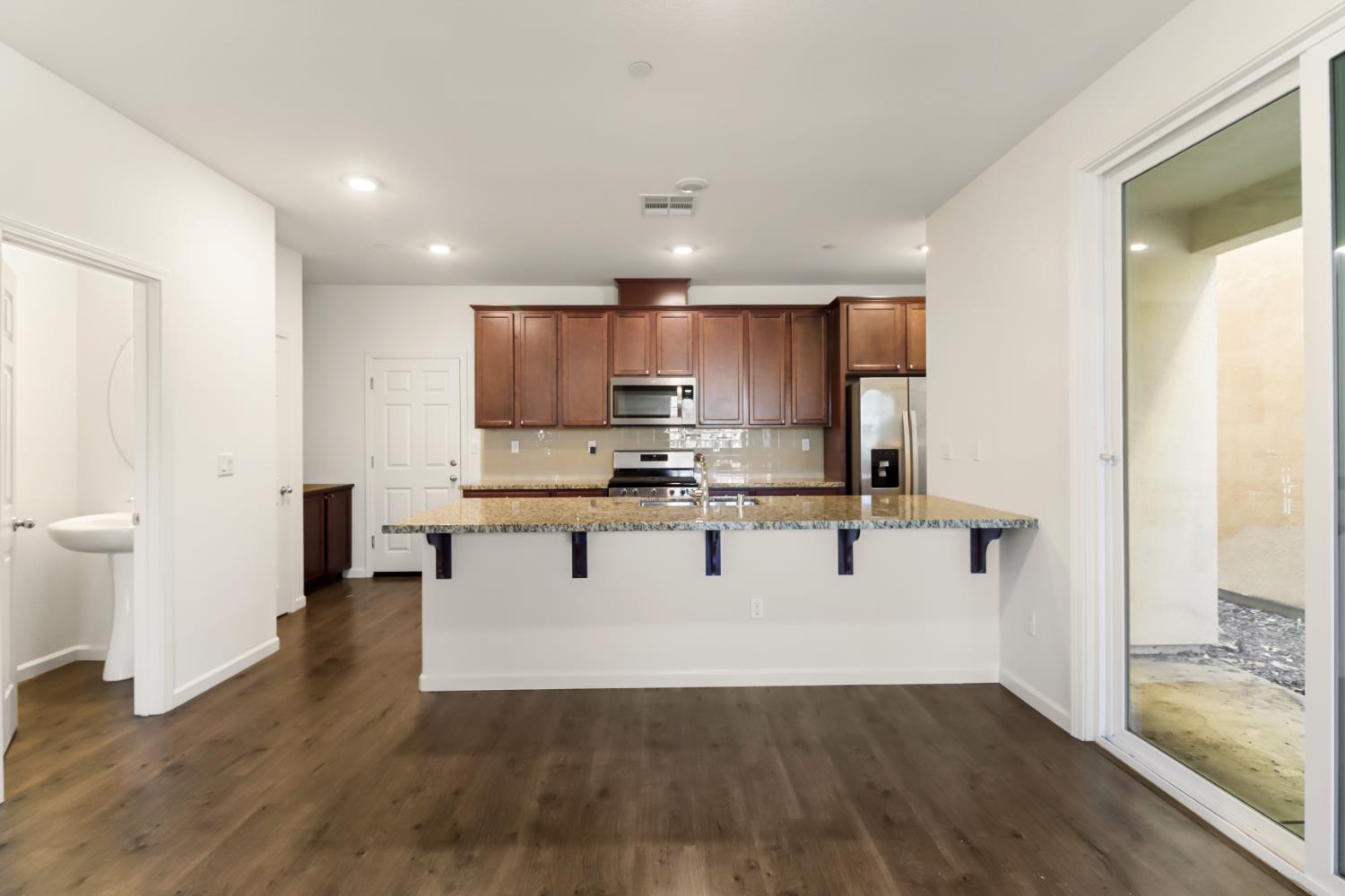 3230 Chelmer Way Rancho Cordova, CA 95670 - Photo 10 of 50 a kitchen with a refrigerator and a stove top oven