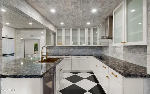 a kitchen with a stove a sink and a refrigerator