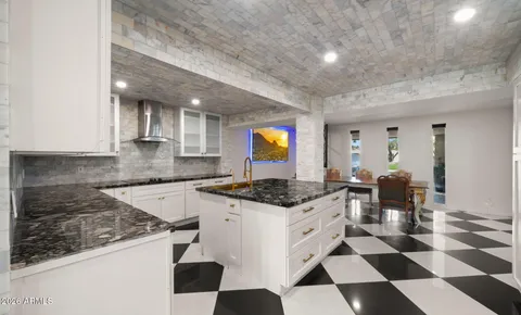 a kitchen with stainless steel appliances kitchen island granite countertop a refrigerator and a stove